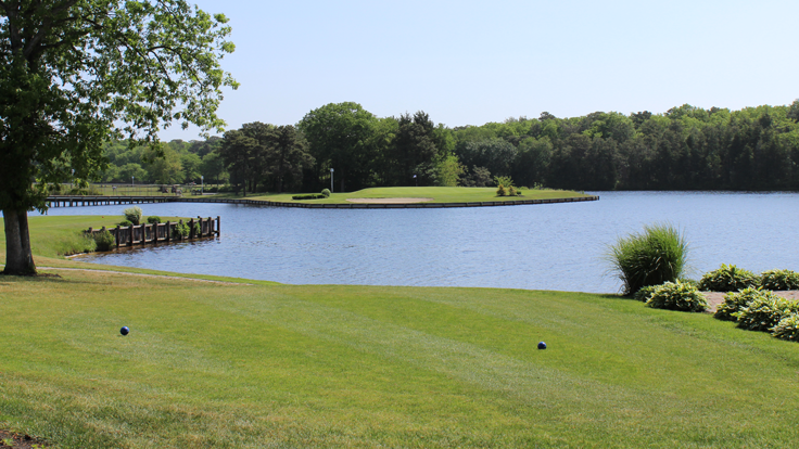 The Par 3 10th Hole with a view from the Championship tee box towards the green complex, which is surrounded by Holiday Lake.